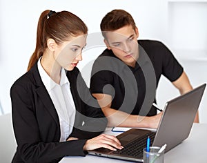 Businesspeople looking at computer screen