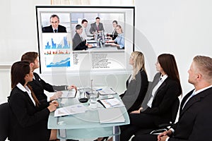 Businesspeople looking at projector screen