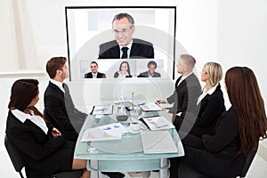 Businesspeople looking at projector screen