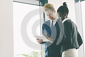 Businesspeople looking at a tablet