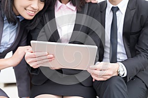 Businesspeople looking tablet and meeting