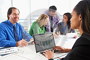 Businesspeople Meeting In Boardroom