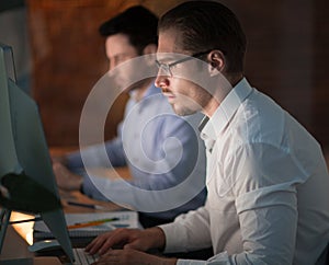 Businesspeople in the office at night working late