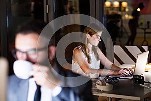 Businesspeople in the office at night working late.