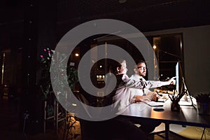 Businesspeople in the office at night working late.