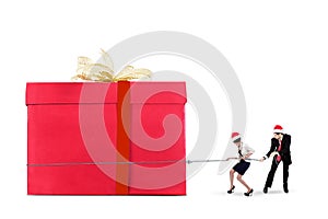 Businesspeople pulling a big gift box