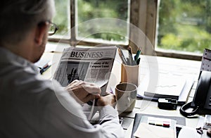 Businesspeople Reading Newspaper at Office Updating News