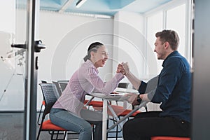 businesspeople, rivalry and people concept - businesswoman and businessman arm wrestling during corporate meeting in