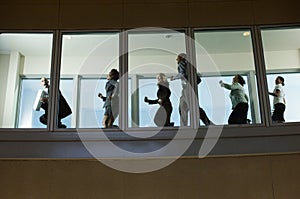 Businesspeople Running Down Hallway