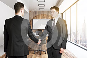 Businesspeople shaking hands in office
