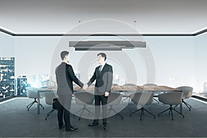 Businesspeople shaking hands in office