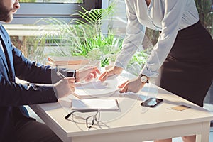 Businesspeople signing documents during meeting