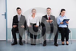 Businesspeople Sitting On Chair For Giving Interview