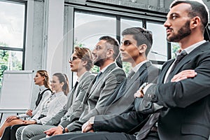 businesspeople sitting on chairs during training in hub