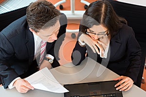 Businesspeople are sitting at office desk