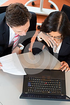 Businesspeople are sitting at office desk