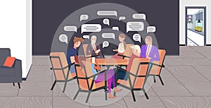 Businesspeople sitting at round table chatting during meeting social network chat bubble communication concept business