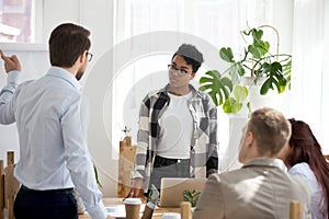 Businesspeople sitting at seminar in conference room indoors