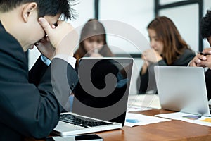 Businesspeople sitting at table in office feeling tired and stressed at meeting room, business concept