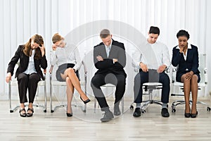 Businesspeople Sleeping In Waiting Room