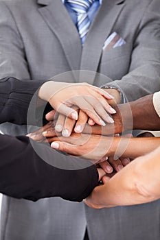 Businesspeople stacking hands