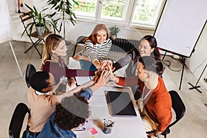 Businesspeople stacking their hands on top of each other