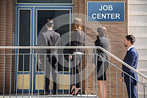 Businesspeople Standing Outside Job Center