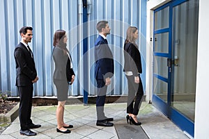 Businesspeople Standing Outside Office Building