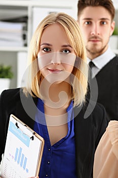 Businesspeople in stylish suits, prepare for biz meeting with client