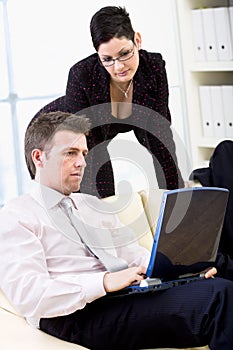 Businesspeople teamworking on laptop