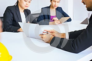 Businesspeople using labtop discussing during meeting together in conference room