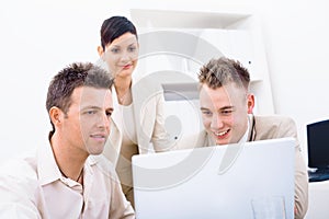 Businesspeople using laptop