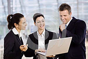 Businesspeople using laptop photo