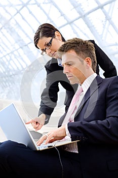 Businesspeople using laptop