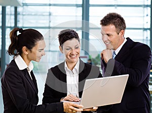 Businesspeople using laptop