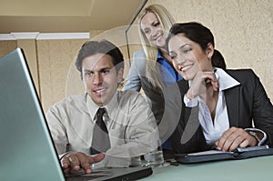 Businesspeople Using Laptop At Conference