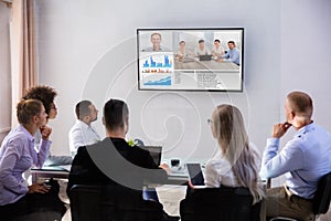 Businesspeople Video Conferencing In Boardroom