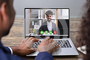 Businesspeople Videoconferencing With Colleague