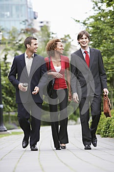 Businesspeople Walking Through City Park