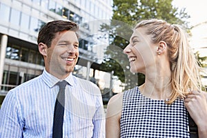 Businesspeople Walking Past Modern City Offices On Way To Work