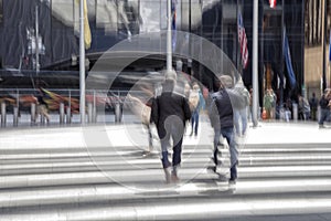 People walking past a office building