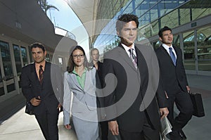 Businesspeople Walking Past Office Building