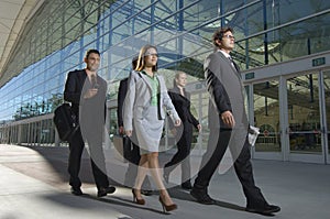 Businesspeople Walking Past Office Building