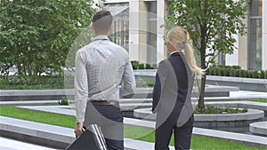 Businesspeople walking on the street of an business center. slow motion
