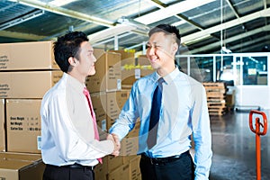 Businesspeople in warehouse have a deal