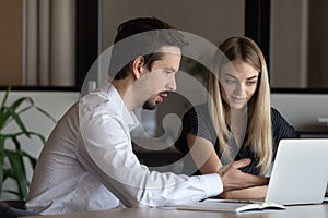 Businesspeople work on computer discuss ideas in office