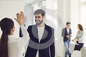 Businesspeople workers give a five hand happy smiling successful project at workplace in modern office