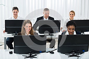 Businesspeople Working On Computers