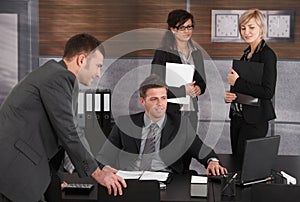 Businesspeople working at desk