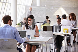 Businesspeople Working At Desks In Modern Office